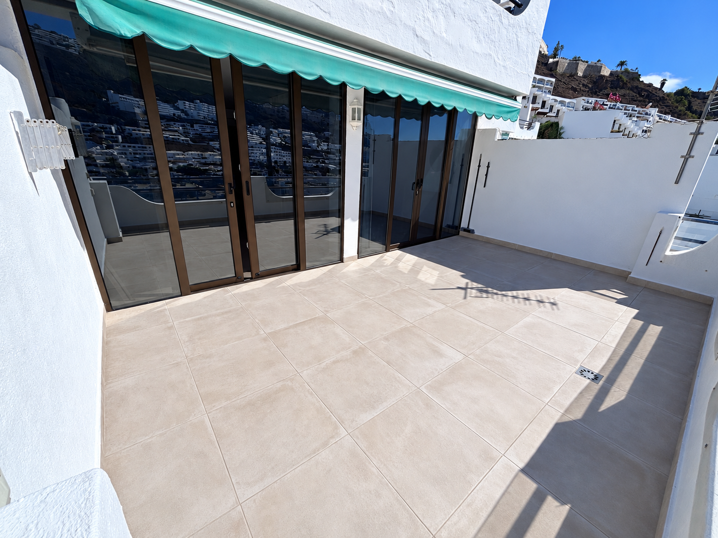 Renovated terrace with falls to the drain, new tiles and new sliding doors